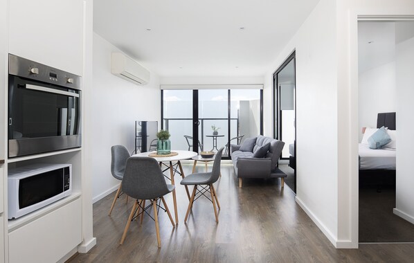 One Bedroom Apartment with Balcony | Living area | 50-inch Smart TV with satellite channels, TV - RNR Serviced Apartments North Melbourne (North Melbourne)