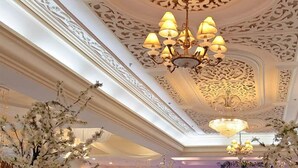 An ornate ceiling with intricate patterns and chandeliers.