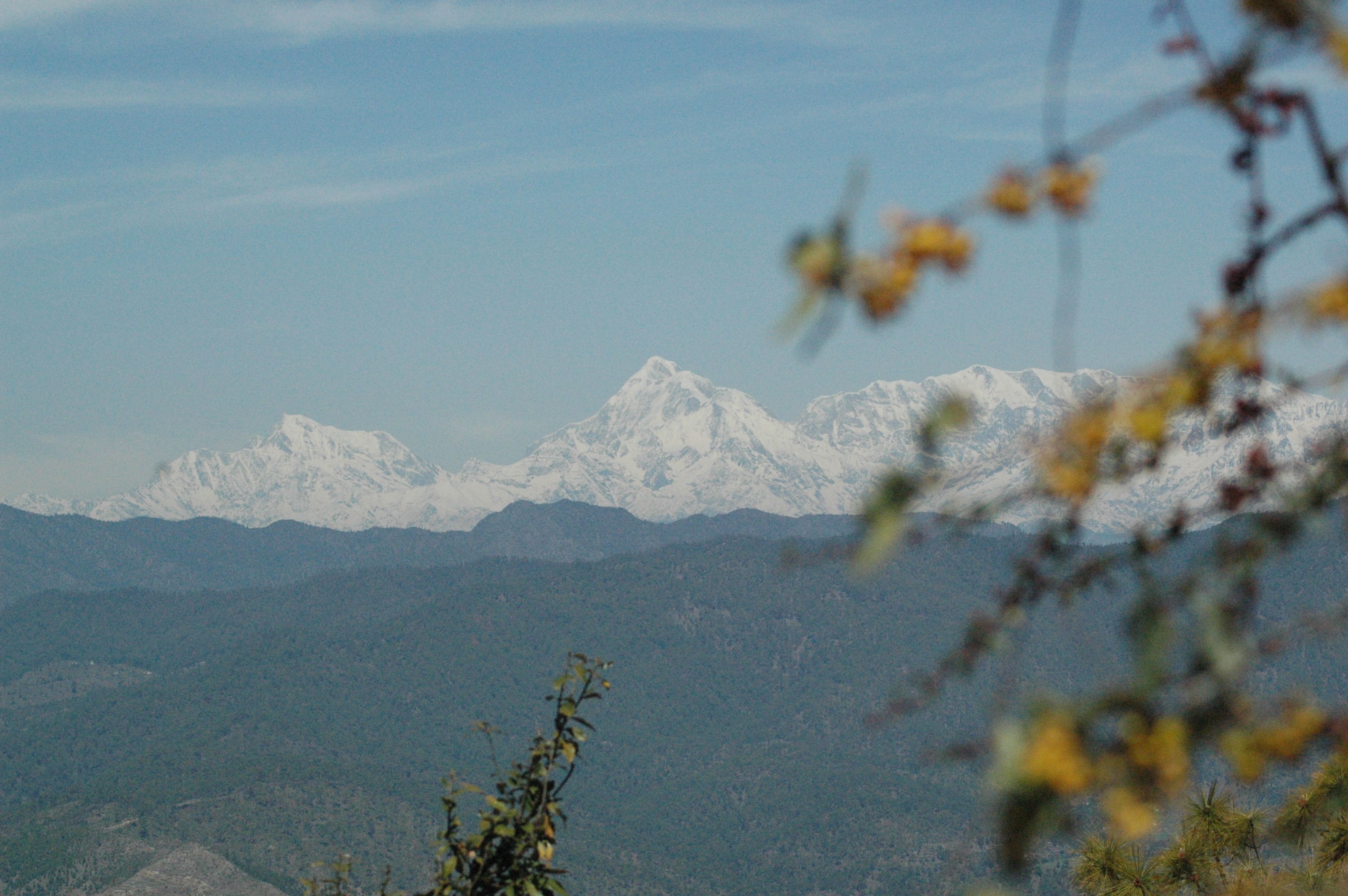 A mountain range with snow-capped peaks and a clear sky.