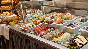 A buffet with various food items including fruits, cheeses, and meats. - Hotel Deutsche Eiche (Munich)