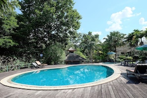 A wooden deck with a swimming pool, lounge chairs, and a gazebo. - Lilawalai Resort (Pak Chong)