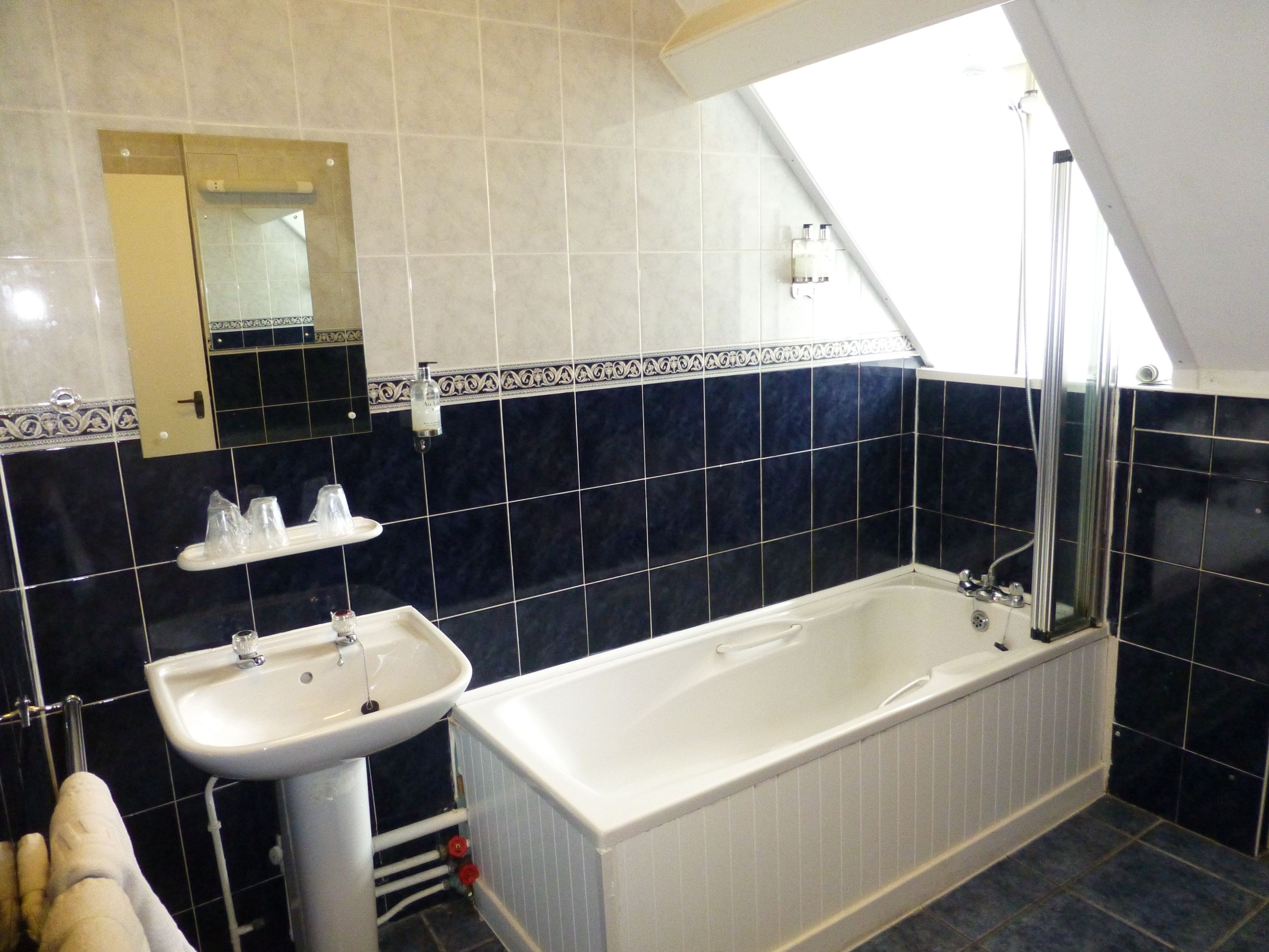 A bathroom with a bathtub, a sink, and a shower.