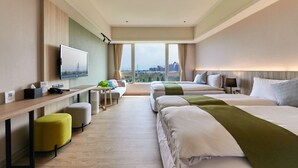 A hotel room with two beds, a desk, a TV, and a view of the city. - Aspire Resort (Taoyuan City)