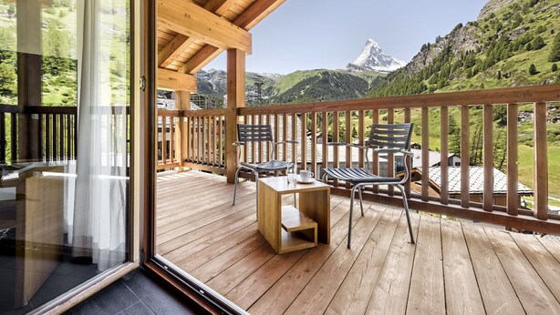A wooden deck with a view of a mountain. - Ari Resort (Zermatt)