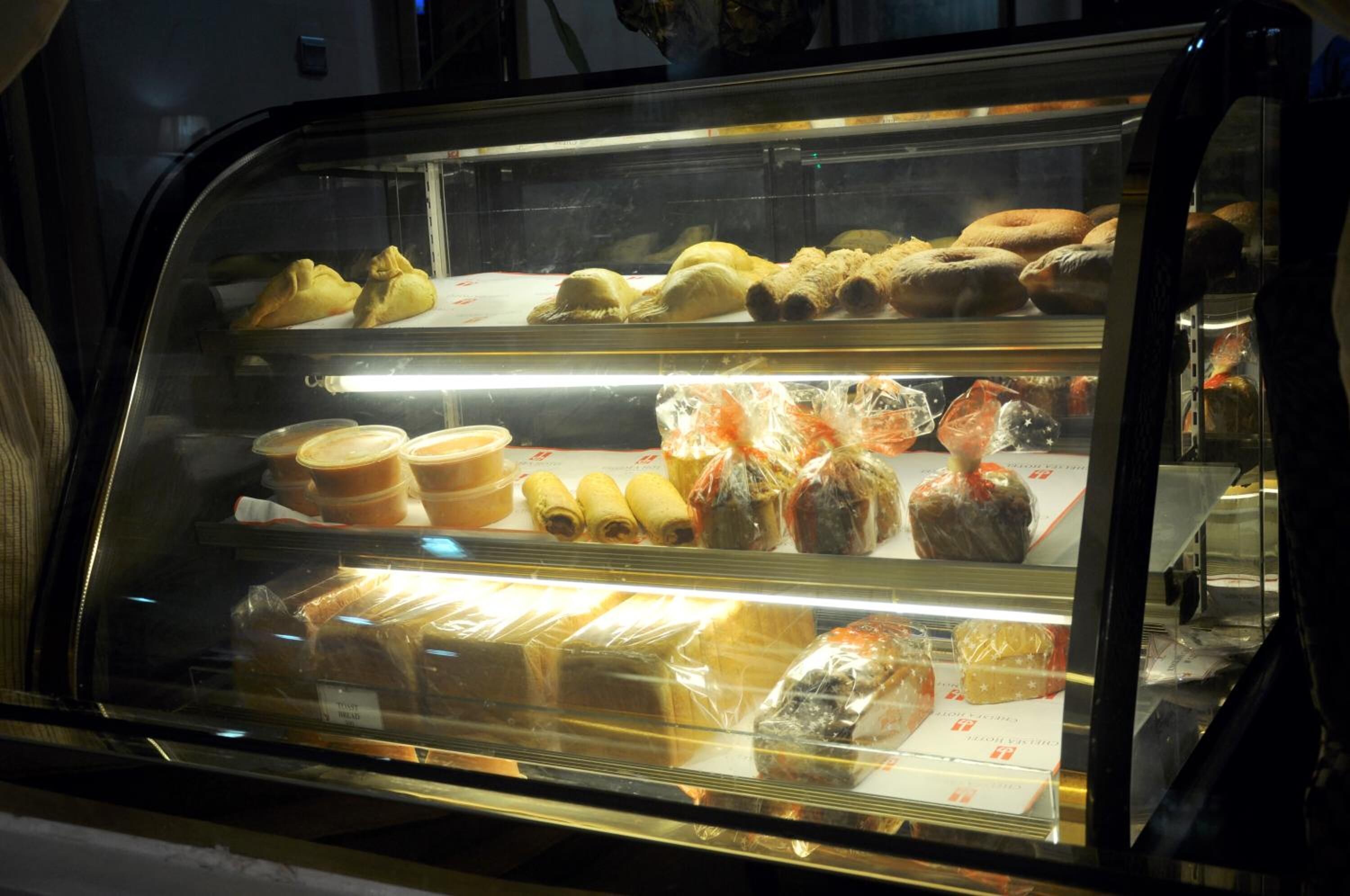A bakery display case with various baked goods.