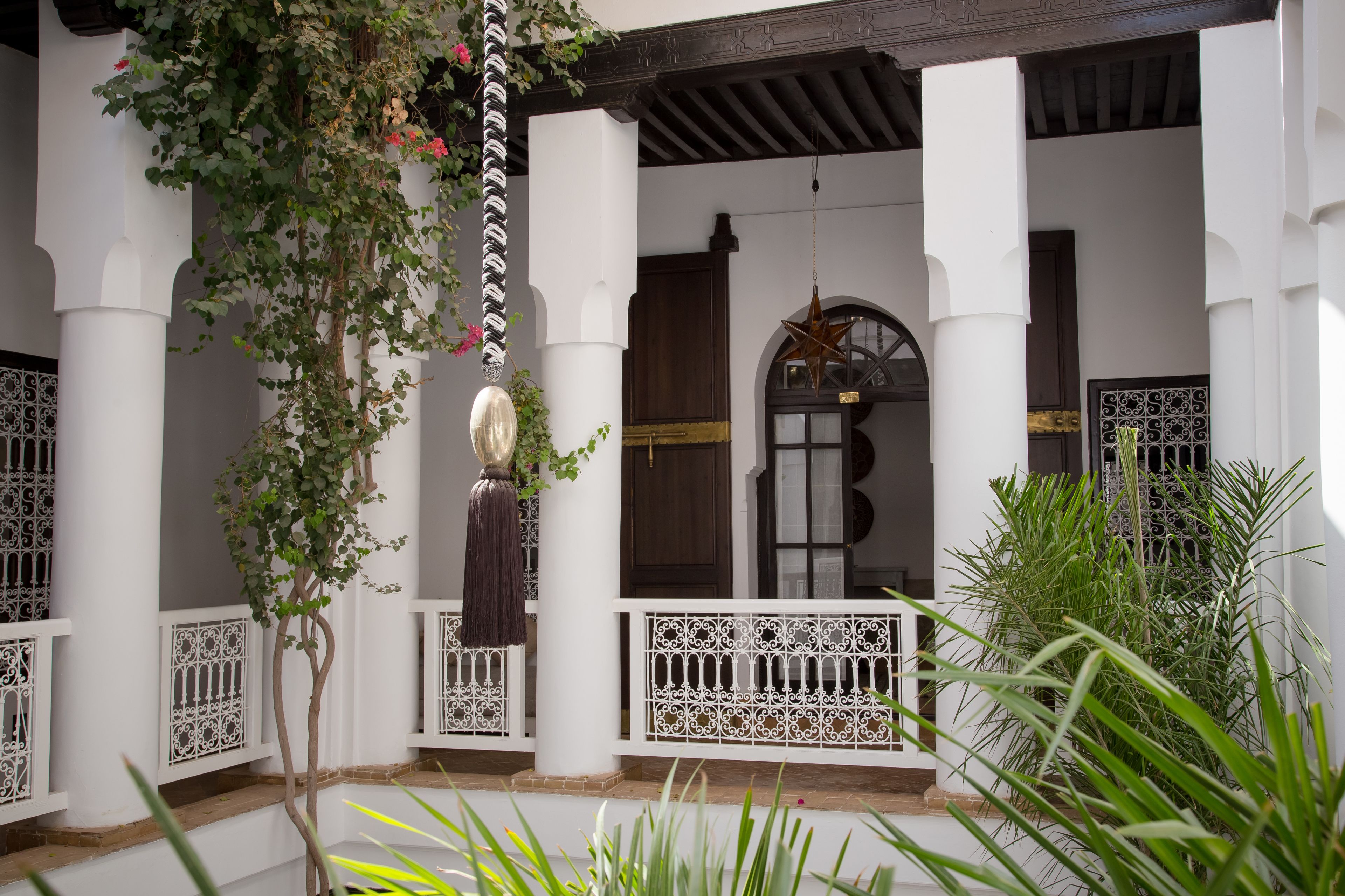 A white building with columns, a decorative star, and a wooden door.
