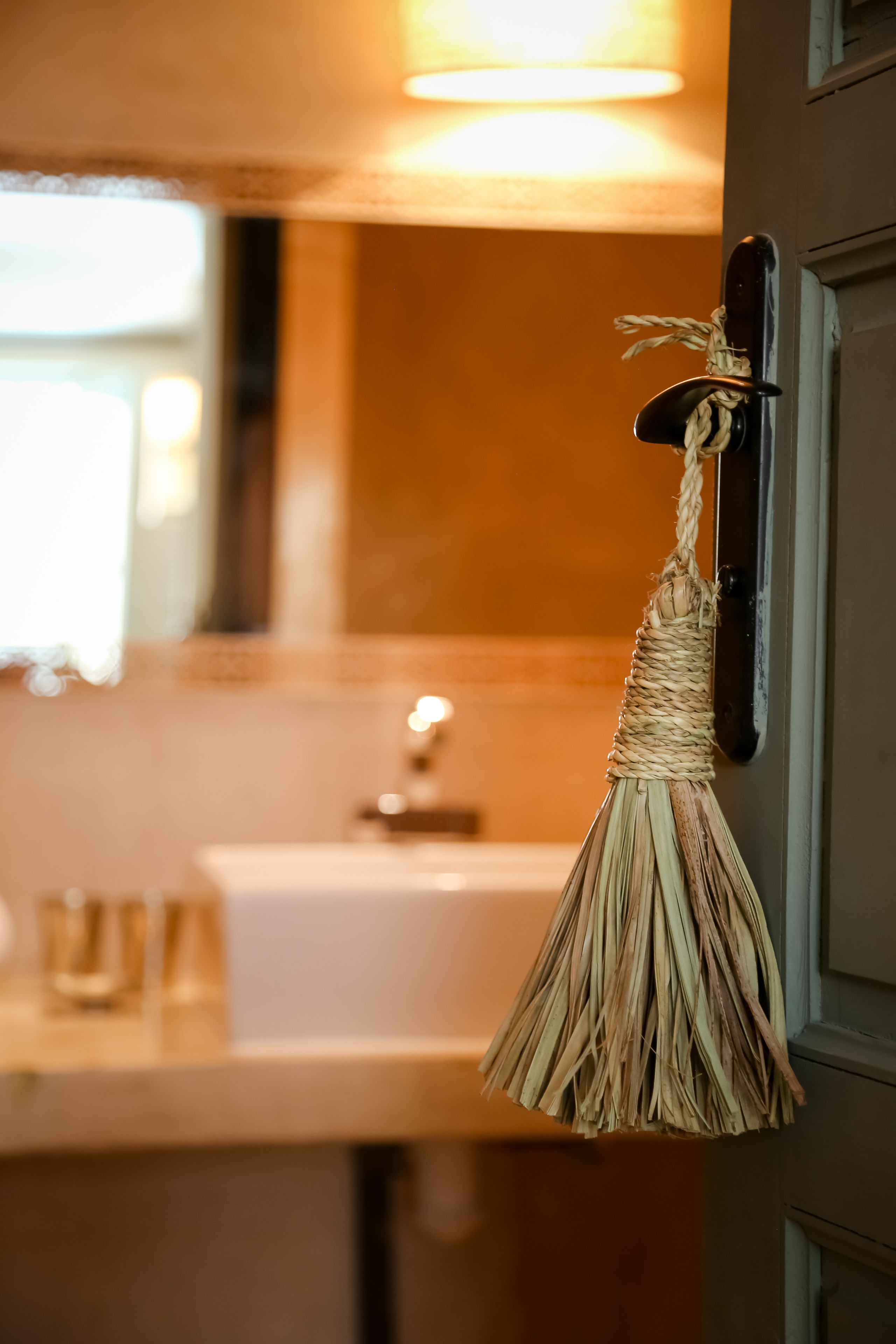 A kitchen with a hanging kitchen towel and a sink.