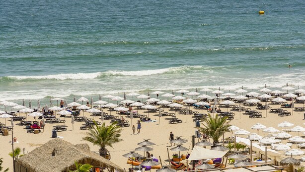 A beach with numerous umbrellas and lounge chairs, a sandy shore, and the ocean in the background. - MPM Hotel Astoria (Sunny Beach)