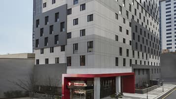 Hotel entrance with a distinctive logo and grid-like windows.