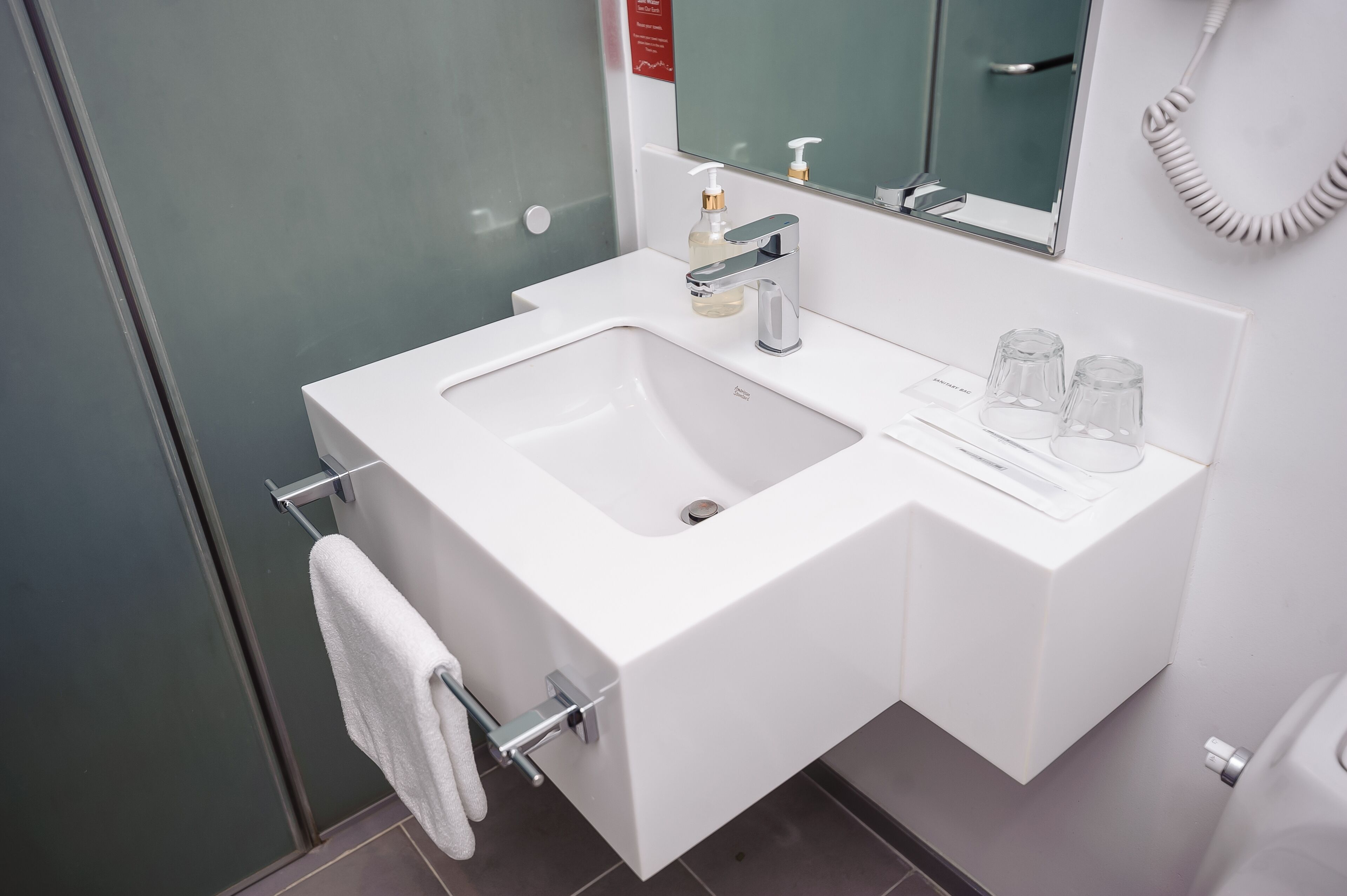 shower, hair dryer, slippers, towels