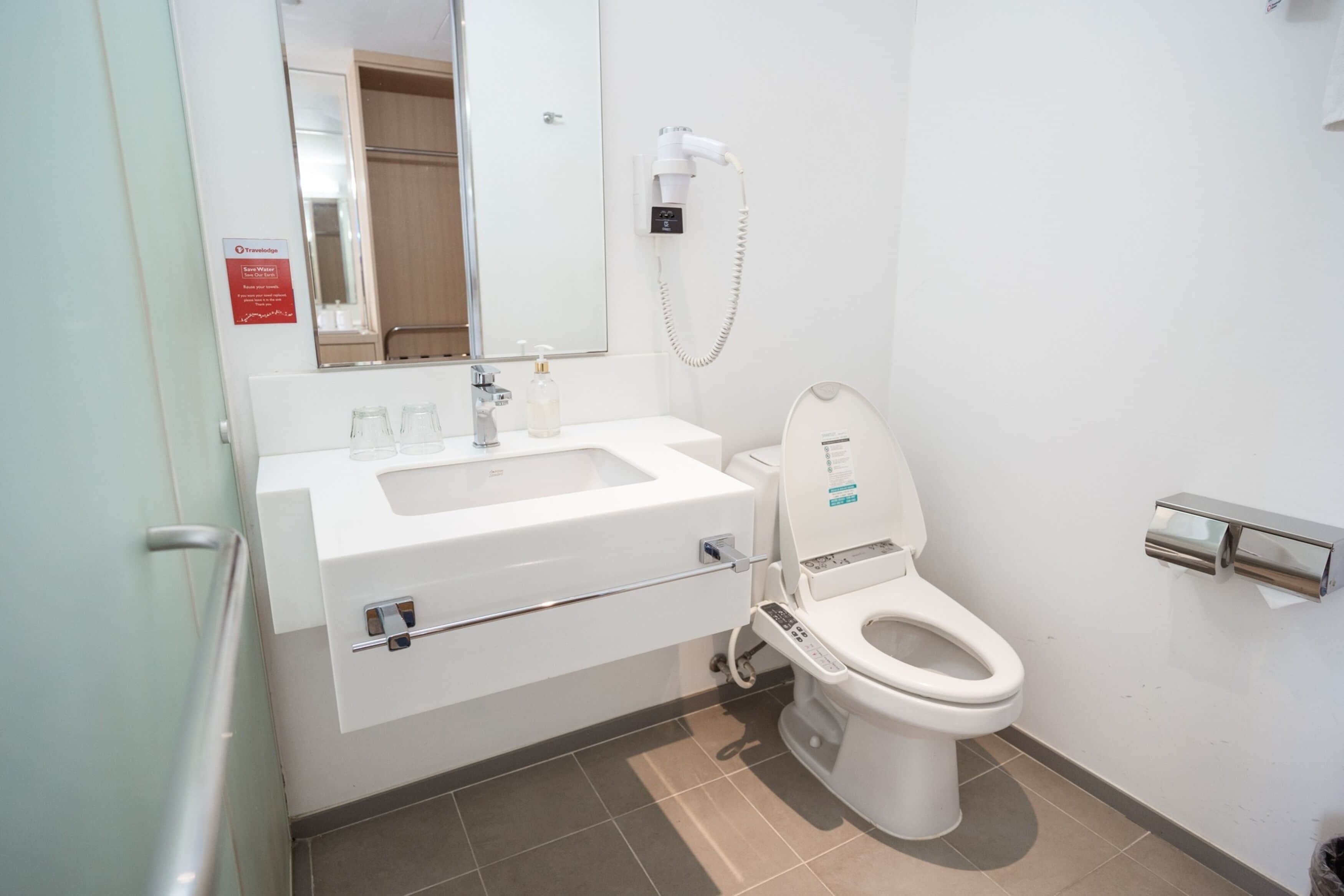 shower, hair dryer, slippers, towels