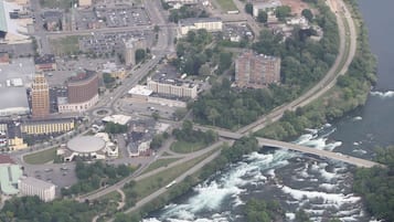 An aerial view of a city with a river, bridges, and buildings.
