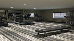 A gym with treadmills, an elliptical, and a weight machine. - Candlewood Suites Smyrna - Nashville by IHG (Smyrna)