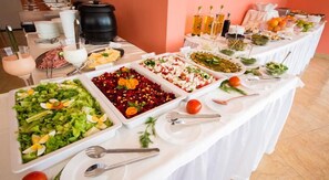 A buffet table with various food items and utensils. - Bohemi (Nessebar)