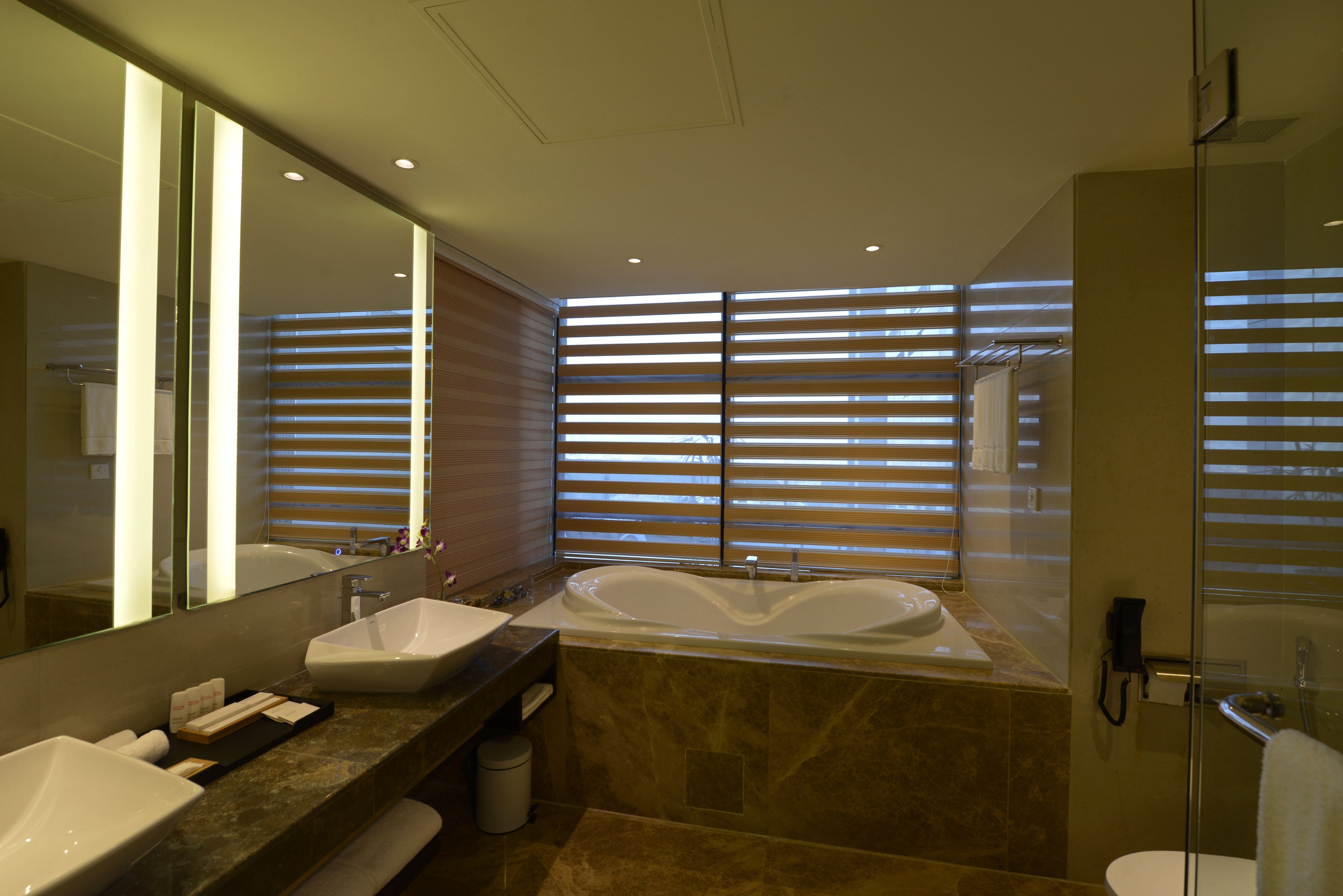 separate bathtub and shower, hair dryer, slippers, towels