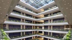A multi-level atrium with glass railings, greenery, and modern lighting. - Radisson Blu Chattogram Bay View (Chittagong)