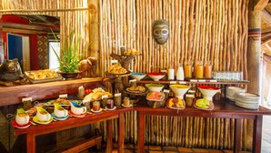 A buffet setup with various food items and beverages. - Lokuthula Lodges (Victoria Falls)