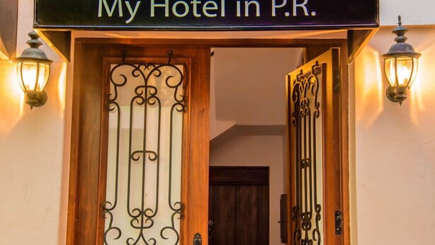 A hotel entrance with a sign reading "My Hotel in P.R." and decorative ironwork on the door. - My Hotel in Puerto Rico (San Juan)