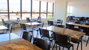 A classroom with tables and chairs arranged for seating. - Floresta Hotel - Expo Anhembi (São Paulo)