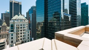 A cityscape with modern high-rise buildings and a historic building with a green dome.