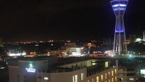 A modern building with a prominent tower, a well-lit plaza, and a clear view of the surrounding cityscape at night. - Fuller Hotel (Alor Setar)
