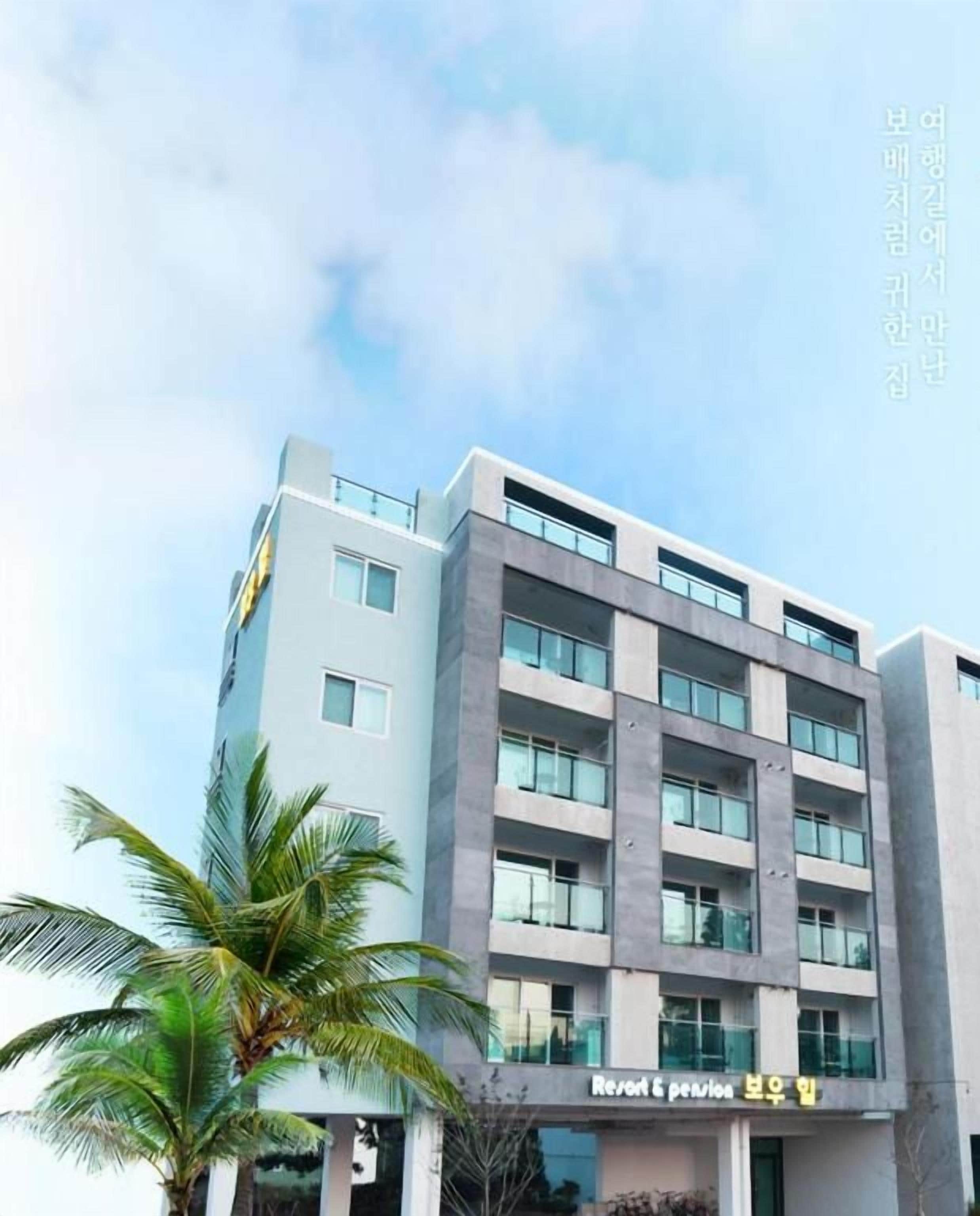 A modern building with a sign that reads "Resort & pension."