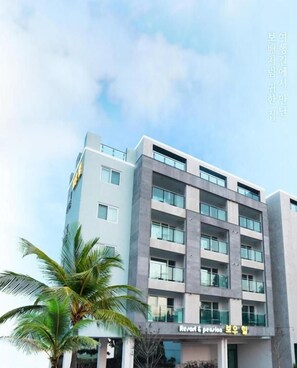 A modern building with a sign that reads "Resort & pension." - Bowoohill (Seogwipo)