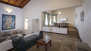 A spacious living area with a sofa, a coffee table, and a dining area in the background. - Hanthana Boutique Villa by Amaya (Kandy)