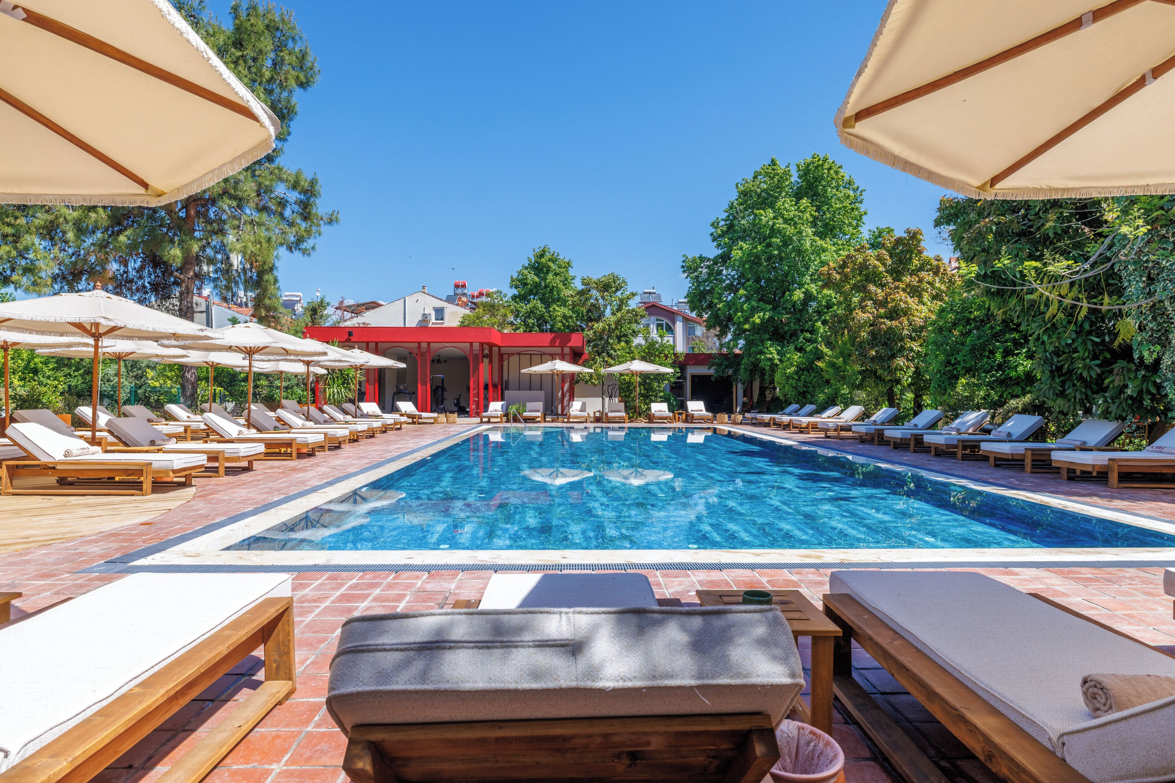 Seasonal outdoor pool, open 10:00 AM to 7:00 PM, pool umbrellas