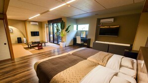 A hotel room with a large bed, a desk, a chair, a potted plant, and a television. - LiVEMAX RESORT Amagi-Yugashima (Izu)
