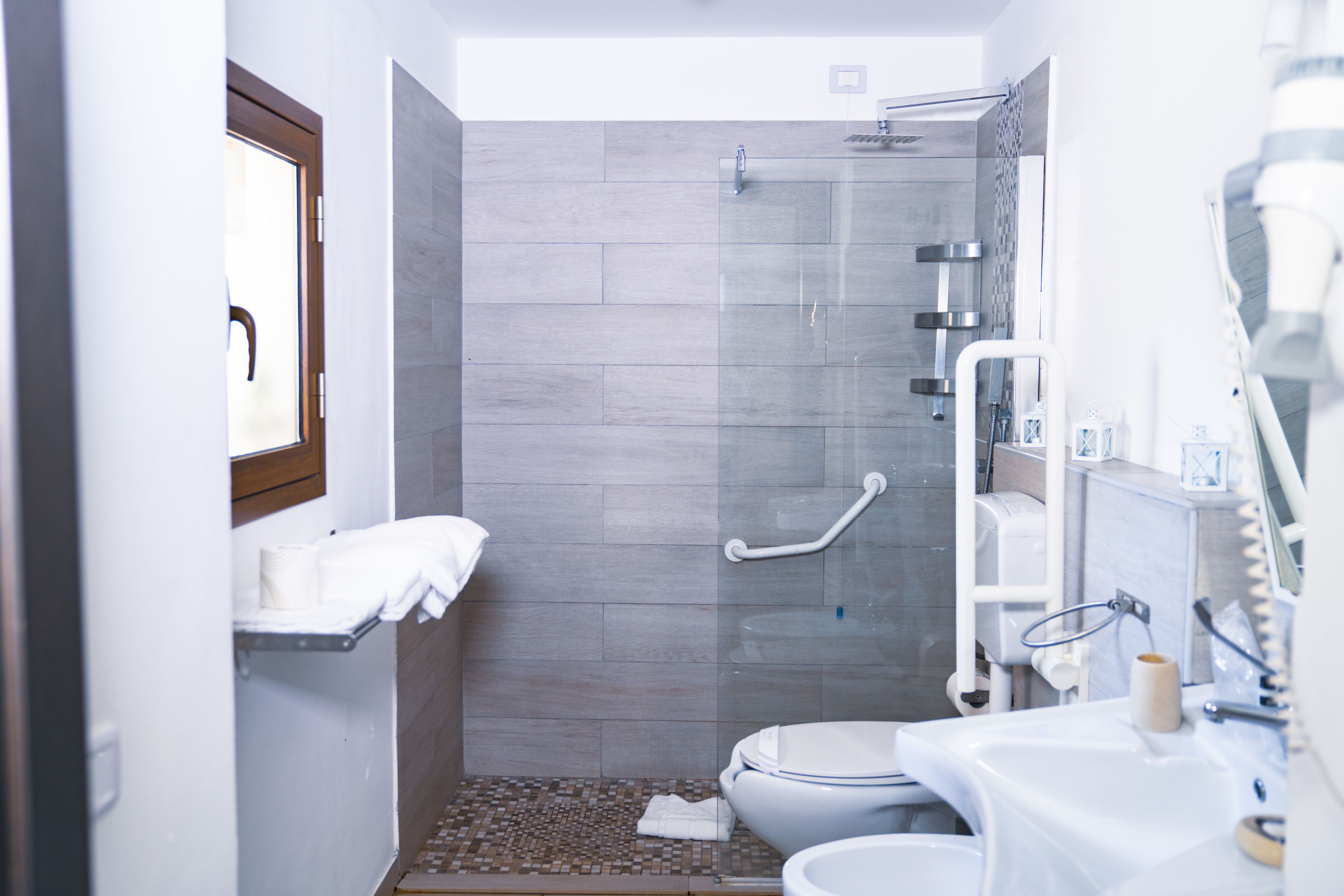 Un baño moderno con ducha, inodoro y lavamanos.