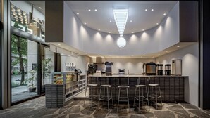 A modern kitchen with a central island, bar stools, and a built-in coffee station. - HYATT - EPISODE Daan Taipei, jdv by Hyatt (Taipei)