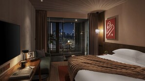 A hotel room with a large bed, a desk with a lamp, a TV, and a balcony with a city view. - HYATT - EPISODE Daan Taipei, jdv by Hyatt (Taipei)