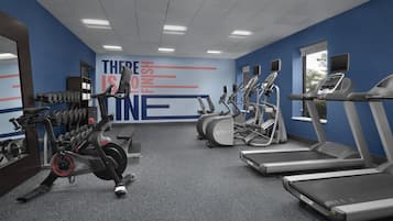 A gym with treadmills, elliptical machines, and dumbbells.