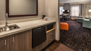 A compact hotel room with a kitchenette, a dining area, and a seating area. - Hampton Inn & Suites Reno West (Reno)