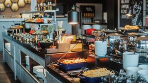 A buffet setup with various food items and utensils. - OREA Resort Devět Skal Vysočina (Snezne)