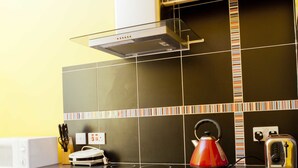 A kitchen with a stove, oven, and toaster.