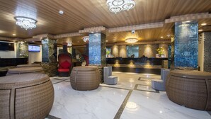 A lobby with a reception desk, wicker seating, and a wooden ceiling. - Diamond Water Edge Resort (Boracay Island)