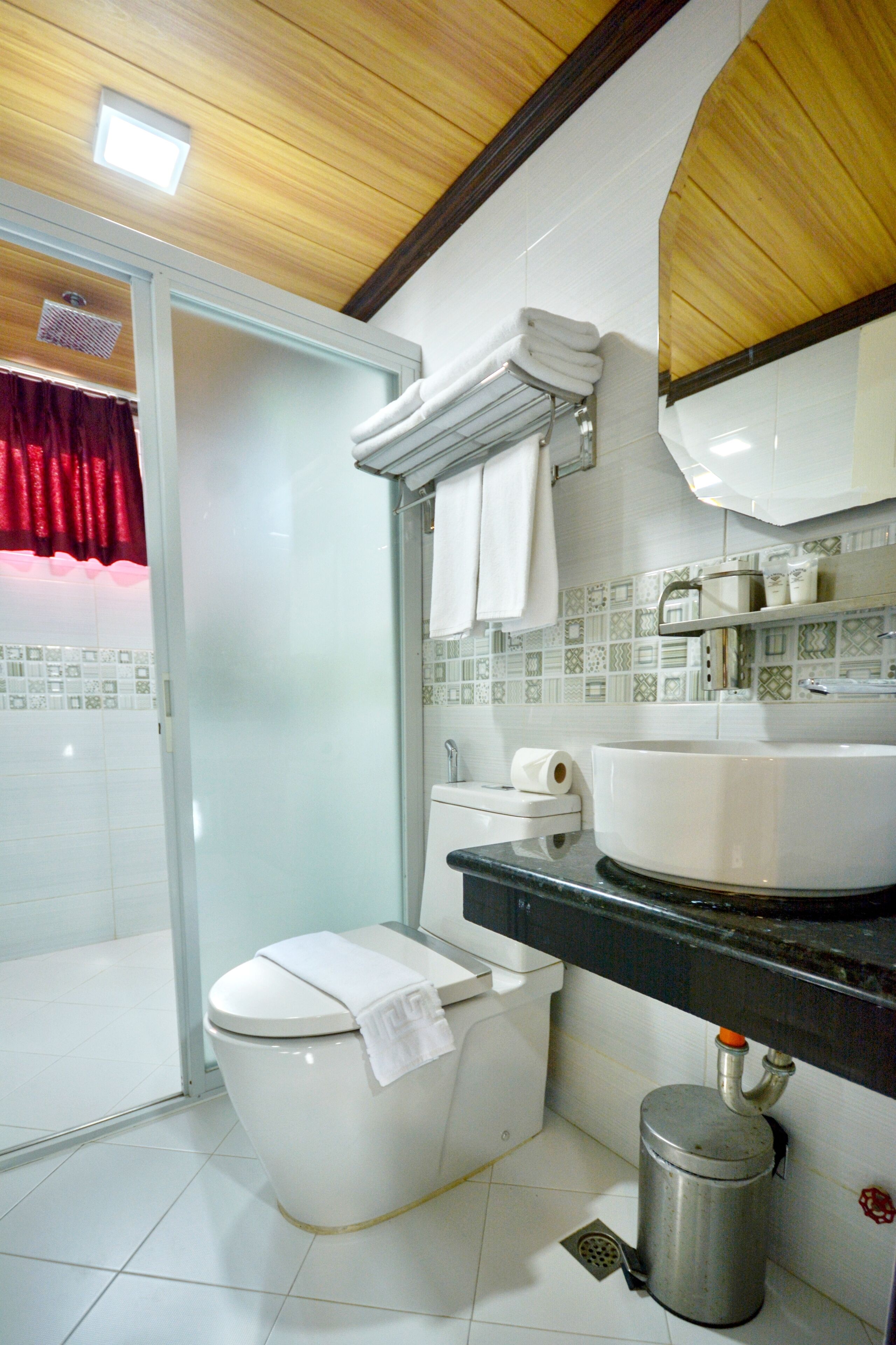 A bathroom with a toilet, sink, and shower.