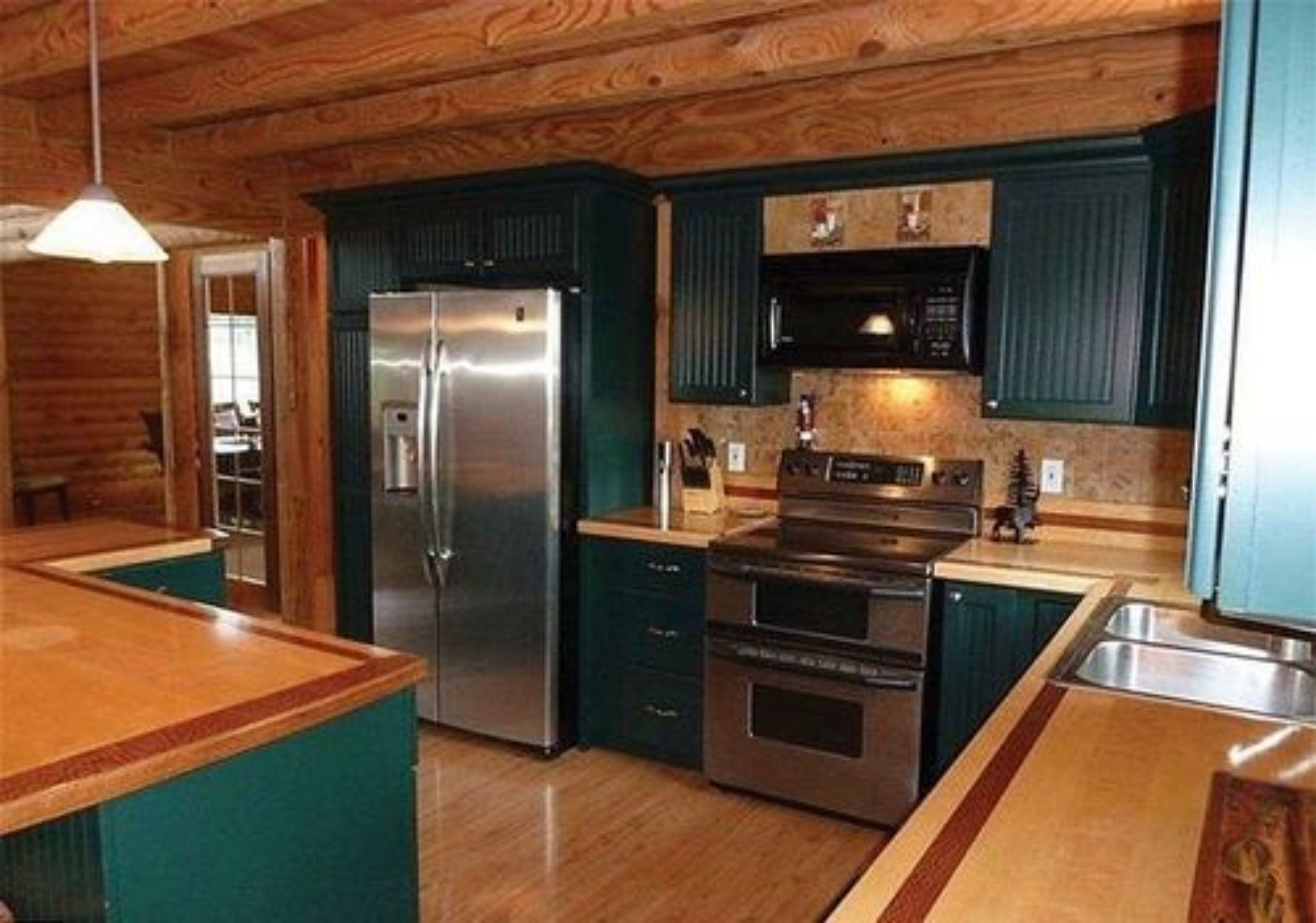 A compact kitchen with a refrigerator, oven, and microwave.