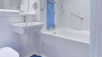 A modern bathroom with a white sink, a toilet, and a bathtub.