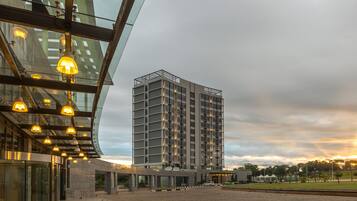 Stylish building with a glass facade and paved entrance.