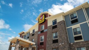A multi-story hotel with a prominent 'MY PLACE' sign, stone facade, and multiple windows. - My Place Hotel - Ft. Pierre, SD (Fort Pierre)
