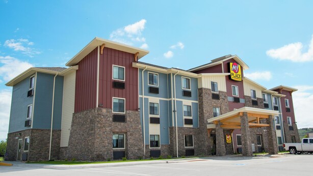 A multi-story hotel with a mix of stone and siding exterior, featuring a prominent 'MY PLACE' sign. - My Place Hotel - Ft. Pierre, SD (Fort Pierre)