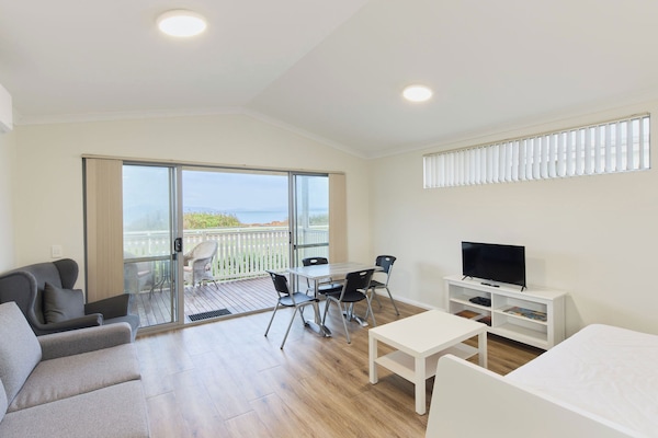 Two Bedroom Seaview Cabin | Living area | 32-inch flat-screen TV with digital channels, TV
