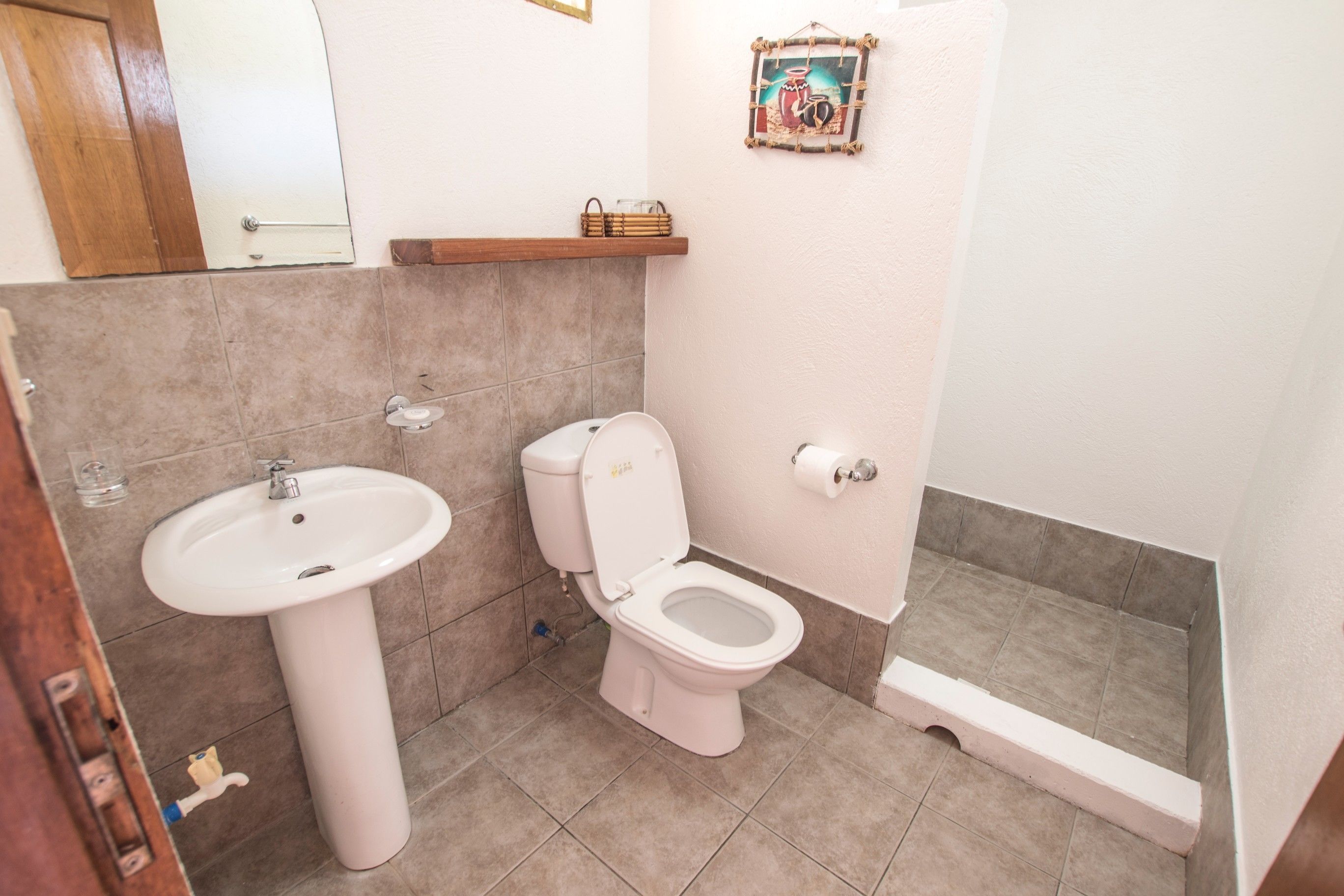 A bathroom with a sink, toilet, and shower.