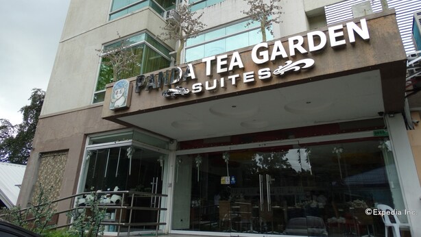A building with a sign reading "Panda Tea Garden Suites". - Panda Tea Garden Suites (Tagbilaran)