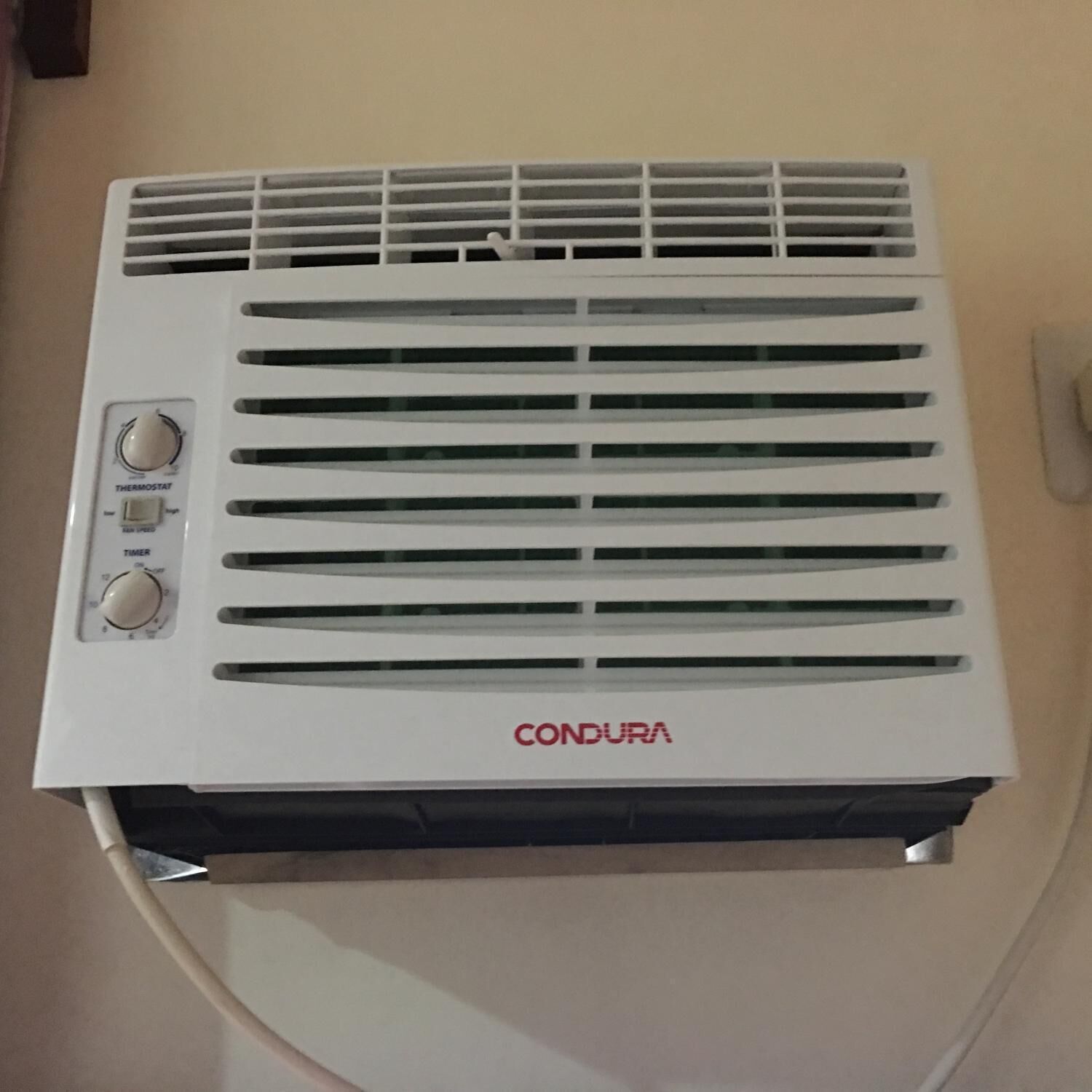 A white air conditioning unit with two dials and a display, labeled 'CONDURA'.