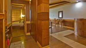 A wooden interior with a bed, a desk, and a mirror. - Vivaan The Sunrise Resort (Manali)