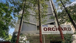 A hotel sign with the name "Orchard" and address. - Hotel Orchard Pune (Pune)